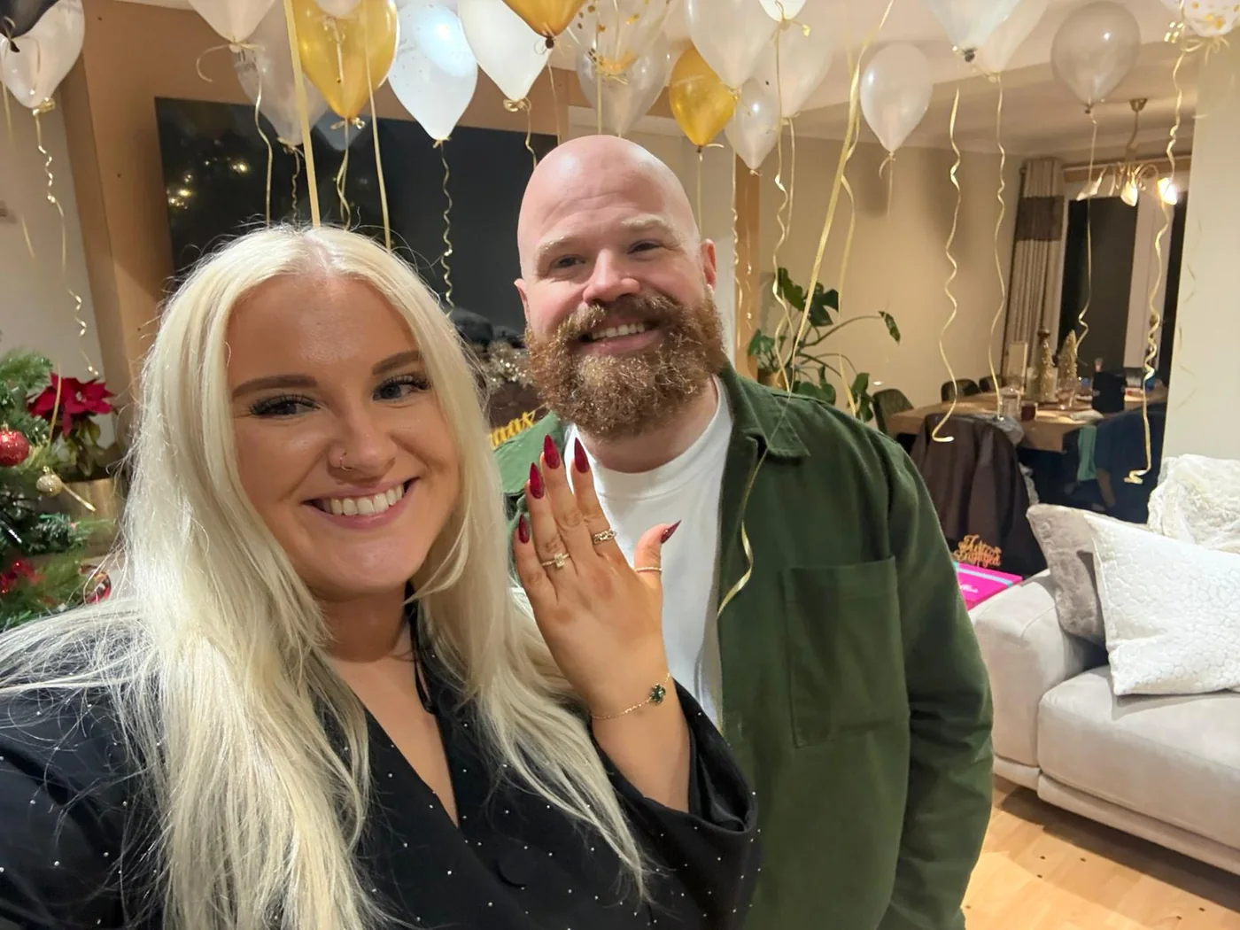 Holly showing her engagement ring beside John